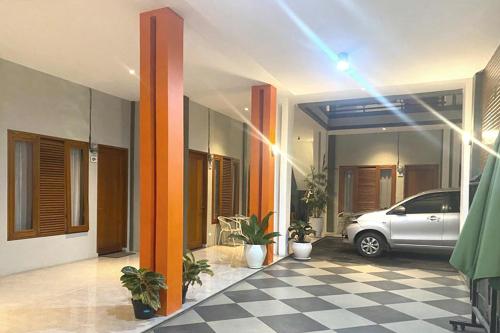 a car parked inside of a house with a checkered floor at Urbanview Hotel Brodam's Pematang Siantar by RedDoorz in Pematangsiantar