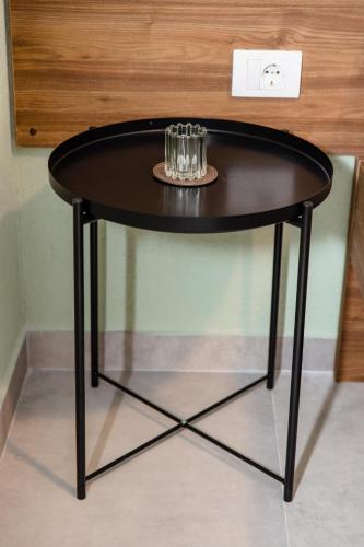 a black table with glasses on top of it at Đerdan Garden apartments in Kraljevo