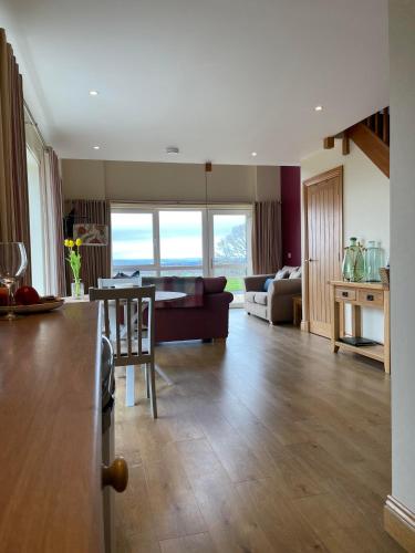 a living room with a couch and a table at Woodside Apartments in St. Andrews