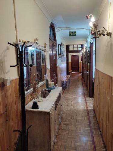a bathroom with a sink and a long hallway at Pensión La Fruta in Avilés