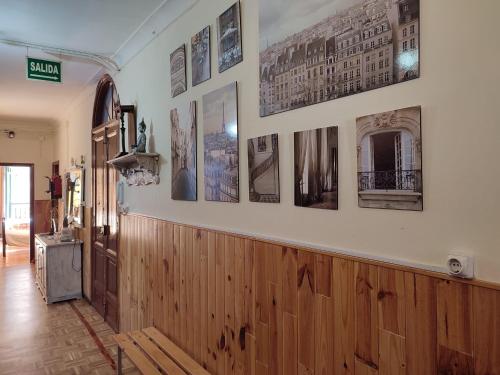 a dining room with pictures on the wall at Pensión La Fruta in Avilés