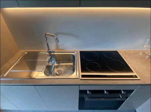 a kitchen sink with a faucet and a sink at Grazioso appartamento con giardino privato in Asti