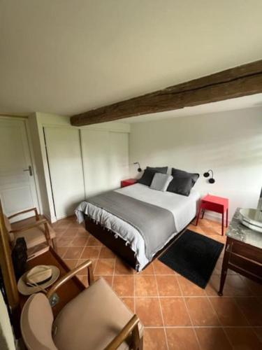 une chambre avec un grand lit dans une pièce dans l'établissement Jolie longère normande pres d'Honfleur et de Deauville, à Les Authieux-sur-Calonne