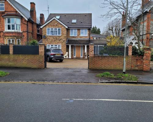 a car parked in front of a brick house at Apartment - Sleeps 2 - Parking - Wi-Fi in Reading
