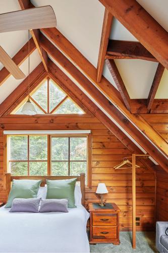 a bedroom with a white bed and a window at Fernhem Cottages- Love in the Mist in Emerald