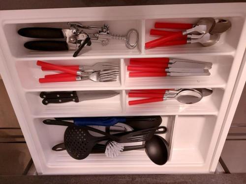 a white drawer filled with lots of cooking utensils at Gemütliche Wohnung in Happenbach in Abstatt