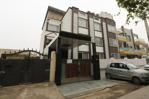 a car parked in front of a building with a gate at Super OYO The Avenue Residency Near Leisure Valley Park in Gurgaon