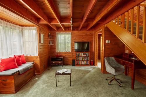 - un salon avec un canapé et un bureau dans l'établissement Fernhem Cottages- Love in the Mist, à Emerald