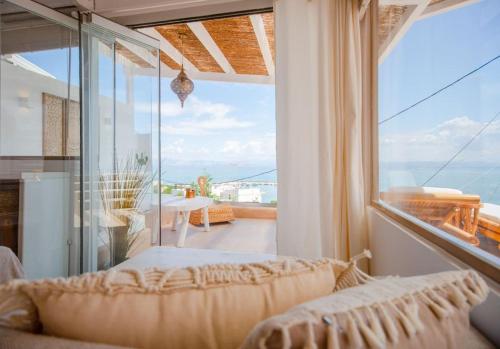 a living room with a couch and a large window at The View in Megalochori