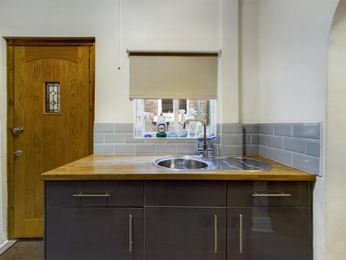 a kitchen with a sink and a wooden door at Rondeva in Chester