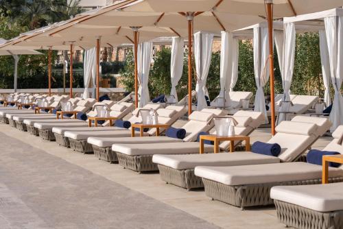 a row of chairs and umbrellas on a patio at Wyndham Residences The Palm in Dubai