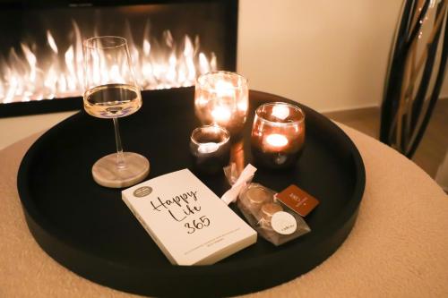 a black table topped with candles and wine glasses at Maison La Belle Cosy 2-bedroom house with jacuzzi & airco in Zoutleeuw