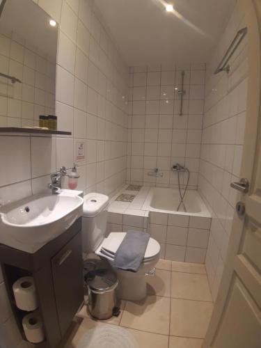 a bathroom with a sink and a toilet and a tub at Villa Venezia in Chania