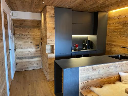 a kitchen with wooden walls and a counter top at Exclusives Apartment im Sonnenhof Moos in Sesto