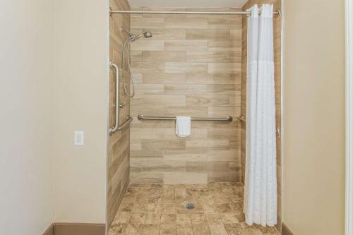 a bathroom with a shower with a shower curtain at MainStay Suites Columbus near Fort Benning in Columbus