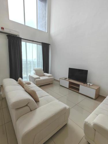 a living room with white furniture and a flat screen tv at METROPOL SERVICED APARTMENT at Bukit Mertajam, Pulau Pinang in Bukit Mertajam