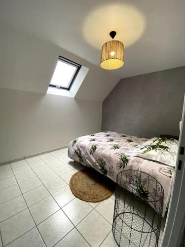 a bedroom with a bed and a window and a rug at L’escale proche château de chantilly in Précy-sur-Oise