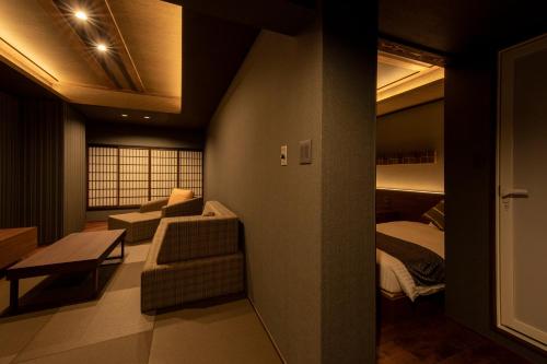 a living room with a couch and a bed at Unzen Fukudaya in Unzen