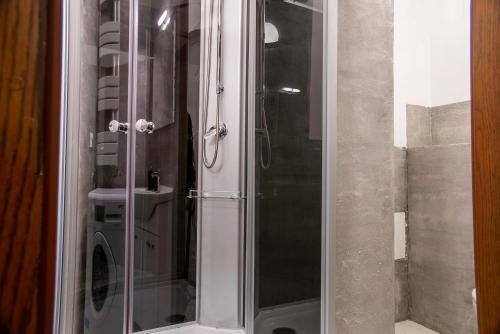 a shower with a glass door in a bathroom at Family&Friends Apartments Schönbrunn in Vienna