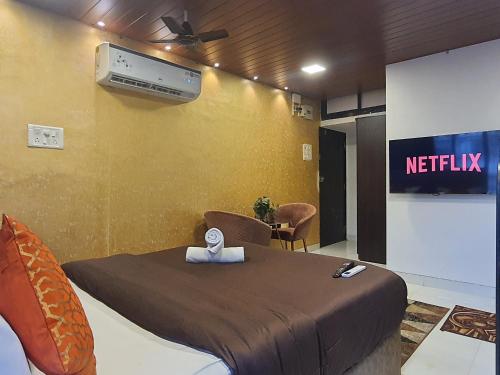 a hospital room with a bed with a netflix sign on the wall at OSI Apartments Carter's Road Bandra West in Mumbai