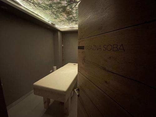 a bathroom with a white sink and a skylight at Pano Kopaonik Panorama in Kopaonik
