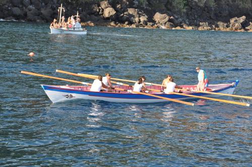 a group of people in a row boat on the water at Casa da Bicuda in Ribeiras