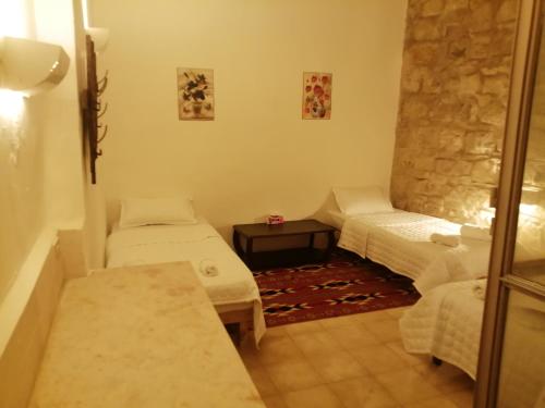 a small room with two beds and a couch at Dana Gardens Hotel in Dana