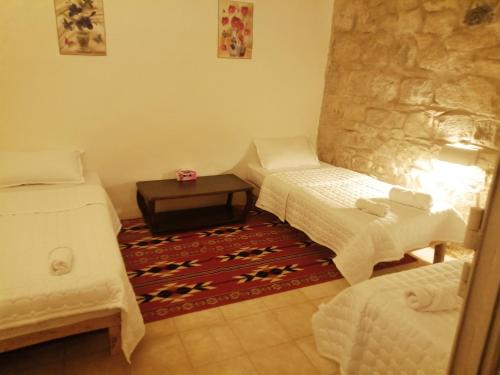 a room with two beds and a table in it at Dana Gardens Hotel in Dana