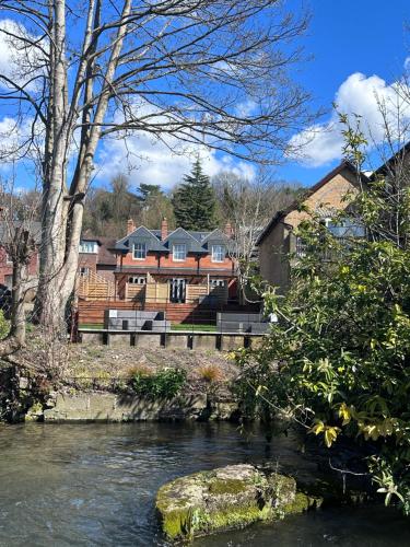 a view of a river with a house in the background at Beautiful house on the River Itchen in Winchester