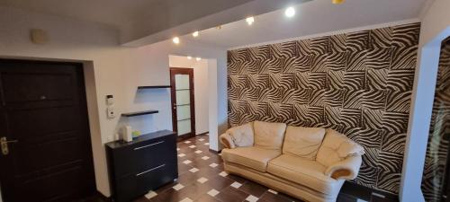a living room with a couch and a wall at M.Dosoftei 126 in Chişinău