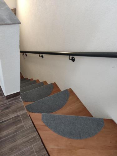 a row of grey carpeted stairs in a room at Old Town Patio House in Ohrid