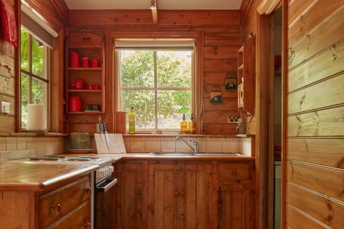 a kitchen with a sink and a window at Fernhem Cottages- Love in the Mist in Emerald