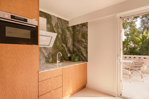 a kitchen with a sink and a stove at Maison Carla Rosa Cannes in Cannes