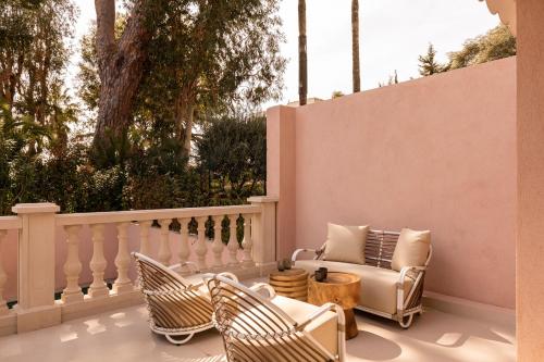a patio with chairs and a couch on a balcony at Maison Carla Rosa Cannes in Cannes