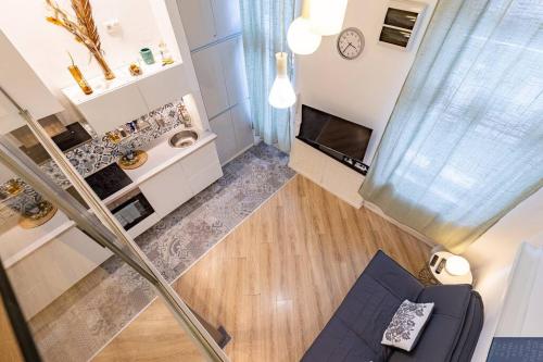 an overhead view of a living room with a clock at Venus Apartments - City Park II in Budapest