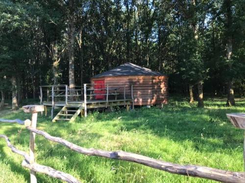 a log cabin in the middle of a field at Domaine de la Puisaye in Grandchamp