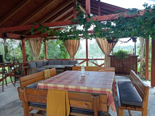 a patio with a table and chairs and a couch at Nárcisz B&B in Corund