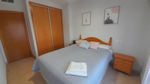 a bedroom with a bed with a tray on it at El Faro de Canet in Canet de Berenguer