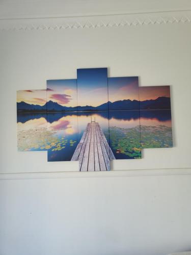 a painting of a dock on a lake at Rainbow Guest House in Lisbon