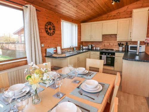 a kitchen with a table with plates and glasses on it at Seascape Retreat in Ilfracombe