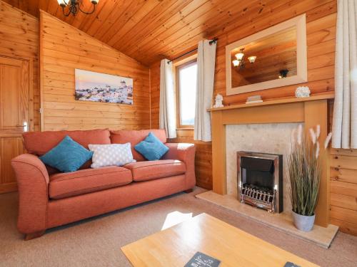 a living room with a couch and a fireplace at Seascape Retreat in Ilfracombe