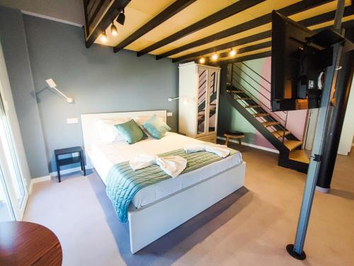 a bedroom with a bed and a staircase at Social Lodge - Happiness in Funchal