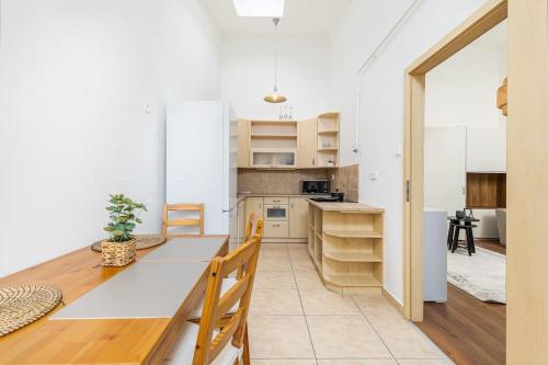a kitchen with a long table and wooden chairs at Venus Apartments - Opera II in Budapest