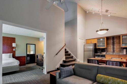 a living room with a couch and a kitchen at Residence Inn Dallas Las Colinas in Irving