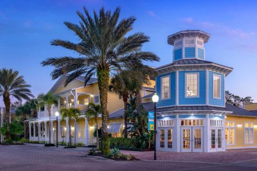 a blue and white house with a palm tree at Marriott's Harbour Lake in Orlando