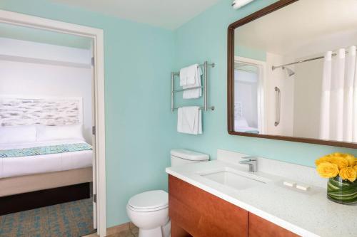 a bathroom with a sink and a toilet and a mirror at Marriott's Harbour Lake in Orlando