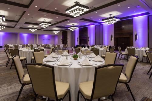 a ballroom with tables and chairs and purple lighting at Baton Rouge Marriott in Baton Rouge