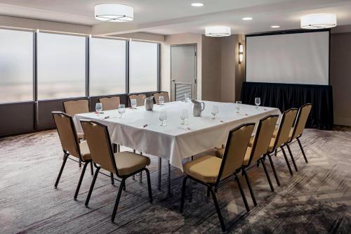 a conference room with a large white table and chairs at Baton Rouge Marriott in Baton Rouge