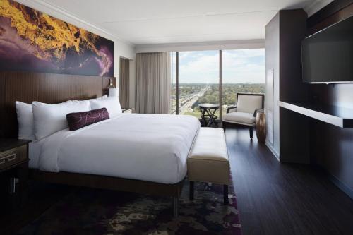 a hotel room with a bed and a large window at Baton Rouge Marriott in Baton Rouge