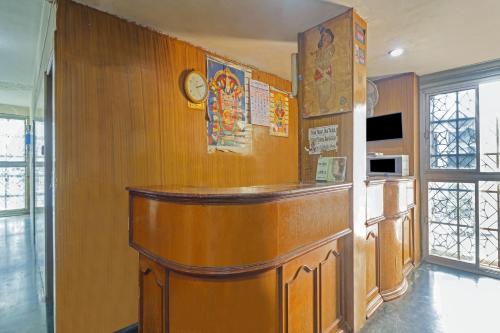 a bar in a room with wooden walls at SPOT ON Gayatri Lodge Near Snow World in Secunderabad